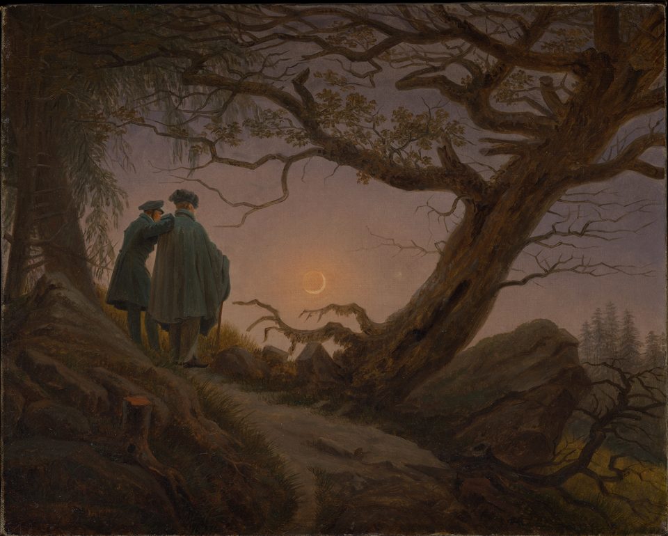A Friedrich oil painting: in a dusky mountain wood two men stand beneath a dead tree, their backs to us, looking at a crescent moon.